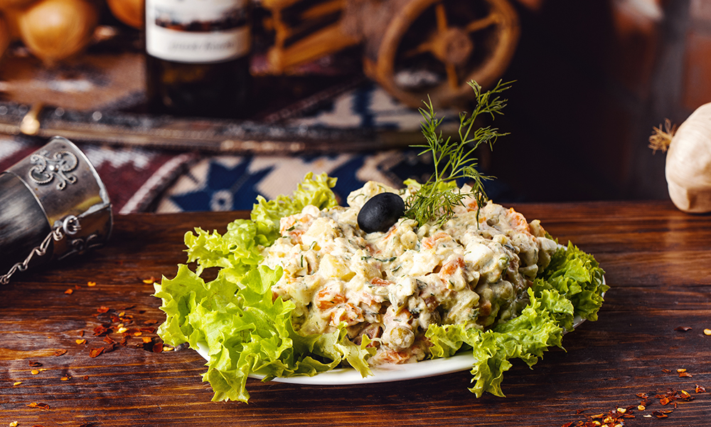 Salad Olivier with chicken fillet at Tbilisuri Ezo Georgian restaurant in Tbilisi }}
